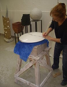 Brigitte Ehnert fron Berlin sanding one of her marble sculptures